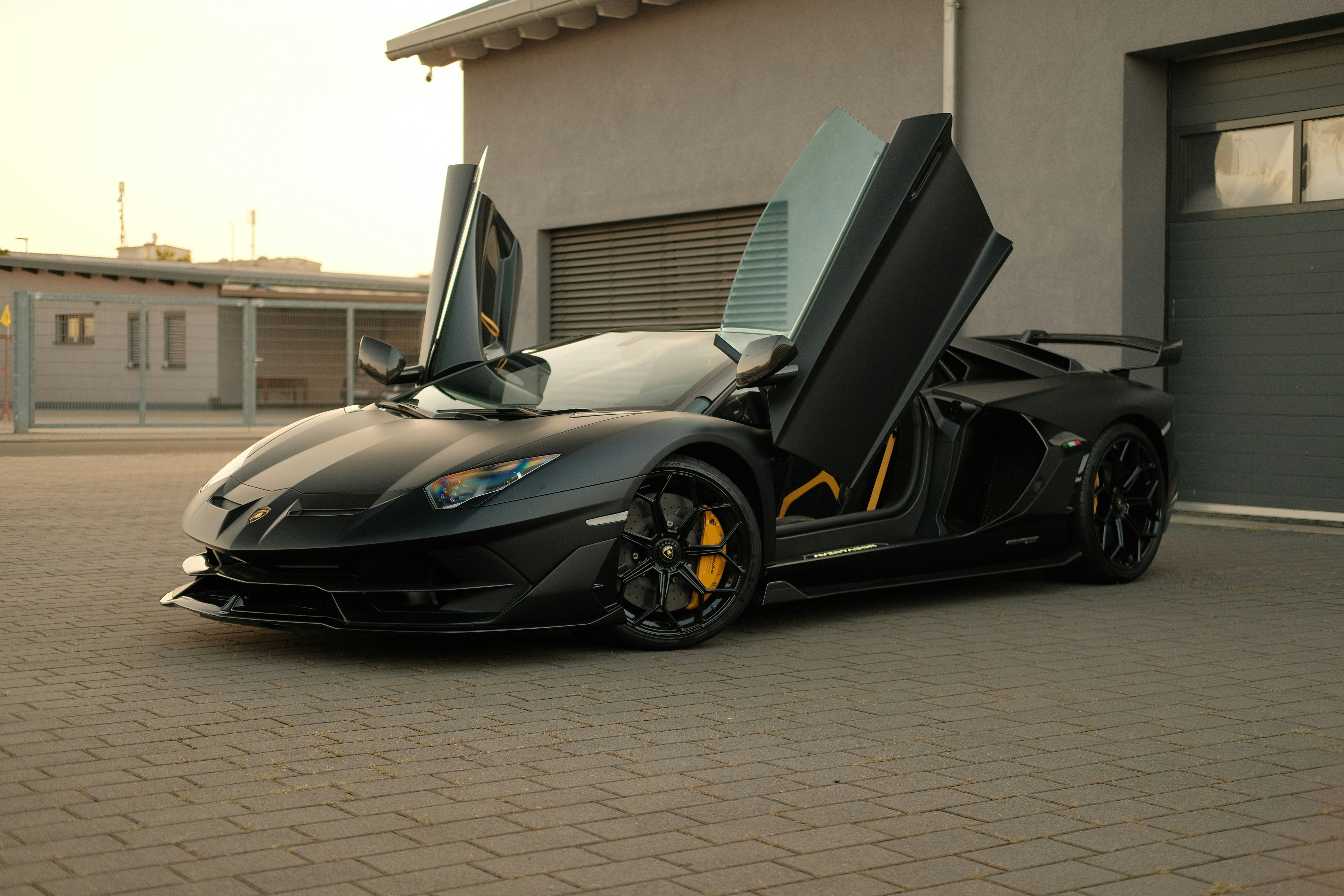 Black Lamborghini Aventador with its doors open